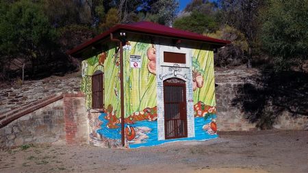 Pumphouse with food market mural at Community Orchard