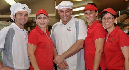 Panini Brothers Staff wearing their white and red uniforms smiling to the camera
