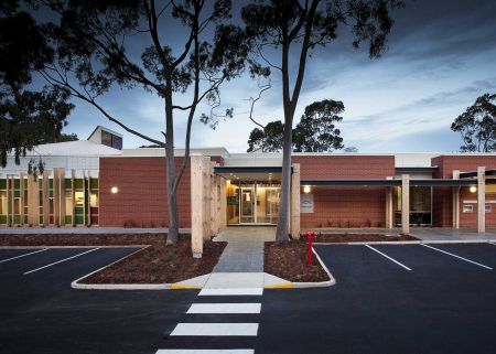 The exterior of the Campbelltown Library building at dusk.
