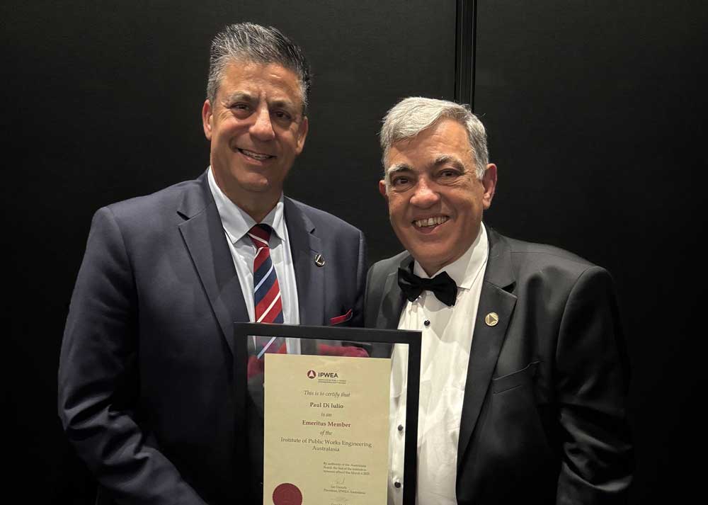 CEO, Paul Di Iulio, holding a certificate for Institute of Public Works Engineering Australasia Emeritus Membership.