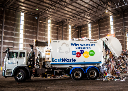An rubbish truck unloading waste at a processing facility.