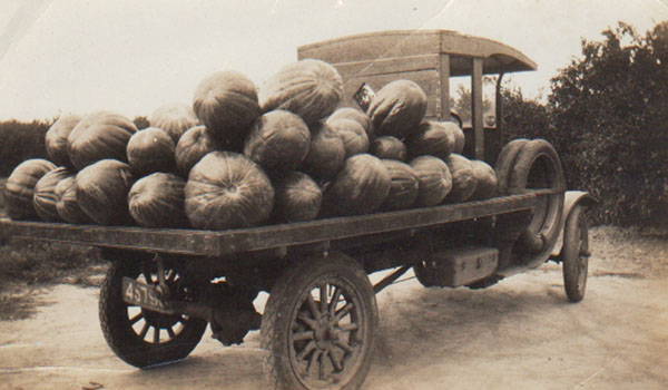 A Ford T truck stacked with vegetables.