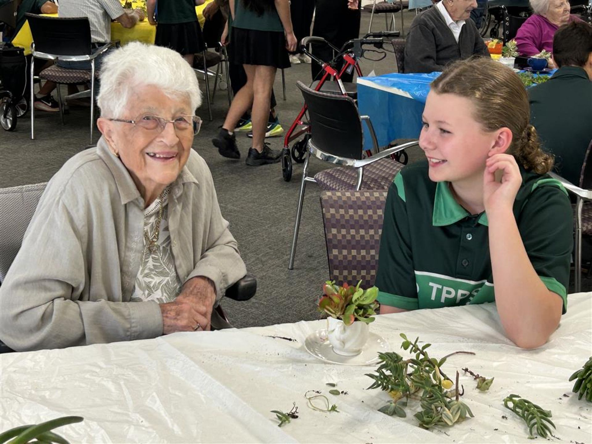 Students from Thorndon Park Primary school making succulent teacups with residents of Resthaven Paradise.