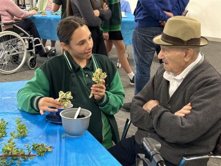 Students from Thorndon Park Primary school making succulent teacups with residents of Resthaven Paradise.