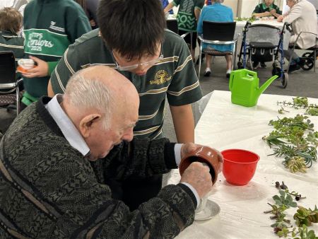 Students from Thorndon Park Primary school making succulent teacups with residents of Resthaven Paradise.
