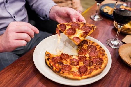 People eating pizza at a restaurant.
