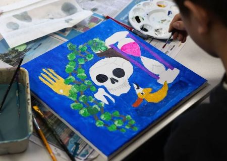 A child painting on a canvas