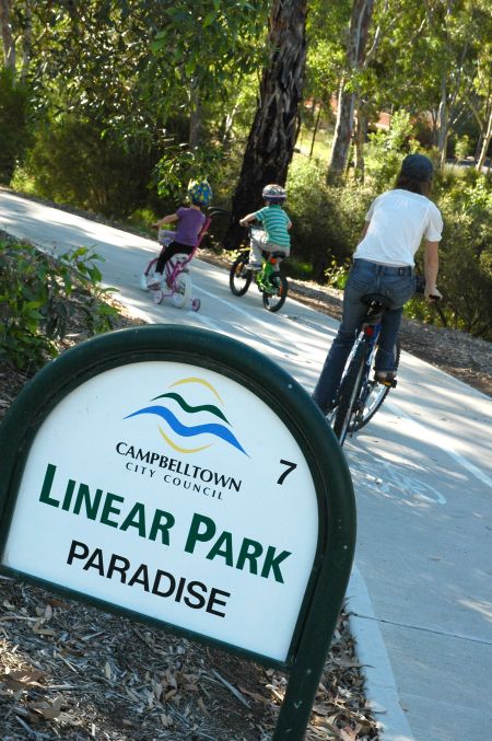 Image of a family cycling along the Linear Park Trail