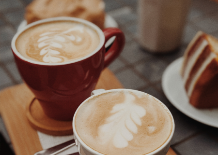 Image of cups of coffee and cake on a table.
