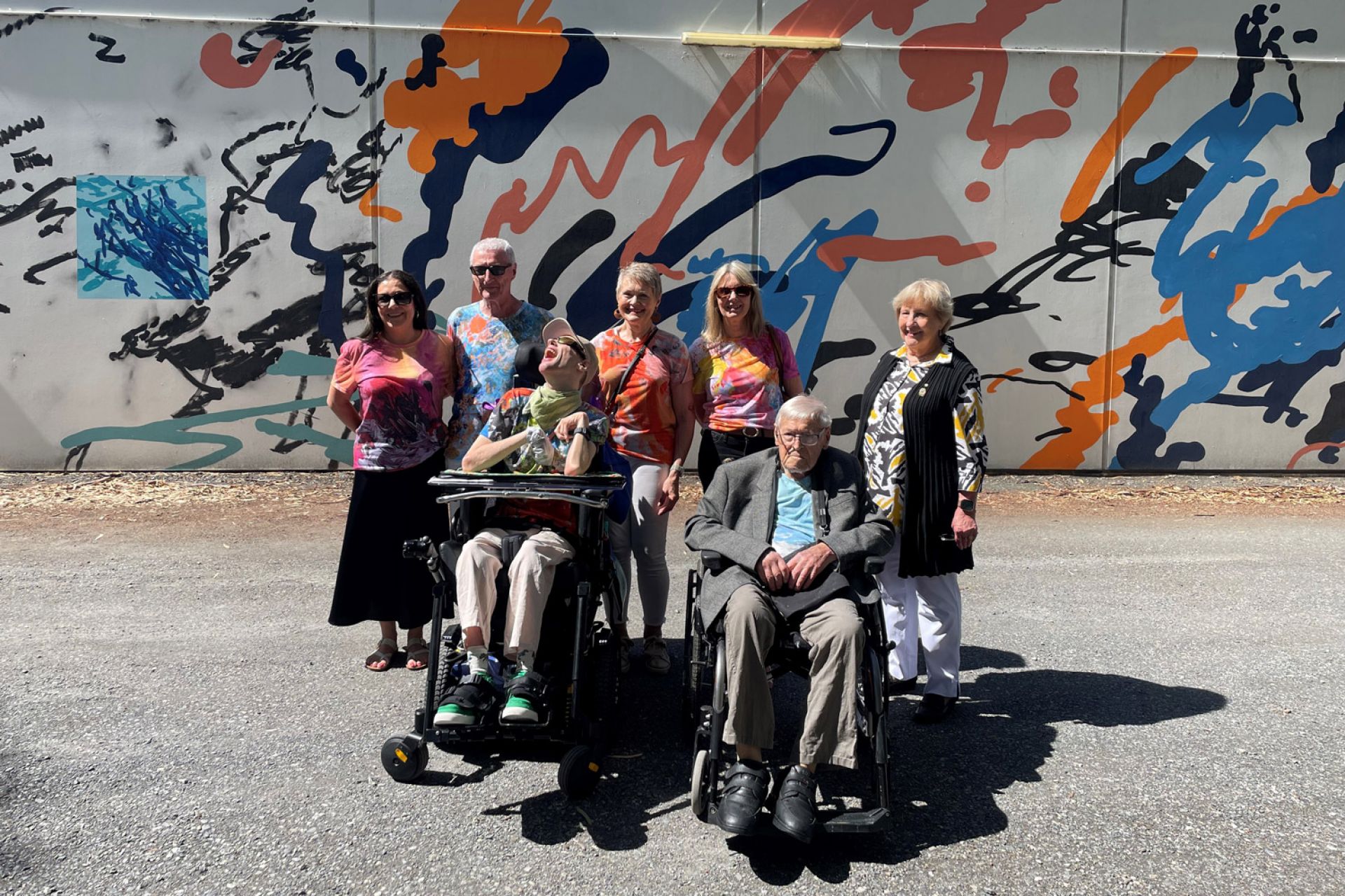 A group of people celebrating the launch of 'Ollie's Mural' at Paradise Recreation Plaza.