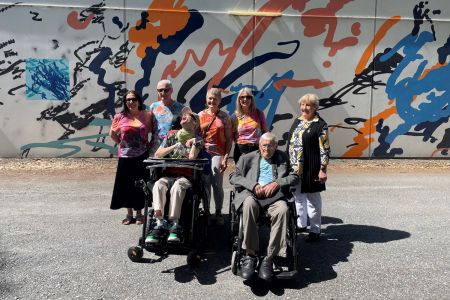 A group of people celebrating the launch of 'Ollie's Mural' at Paradise Recreation Plaza.