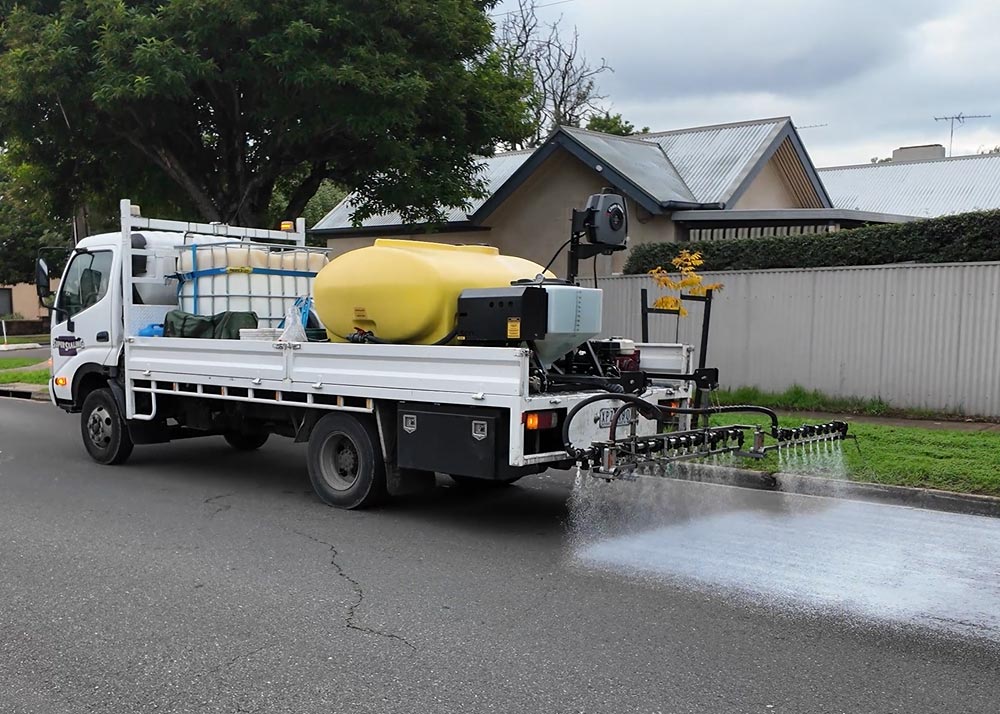 A truck spraying Delta Mist onto a road to rehabilitate the road surface.