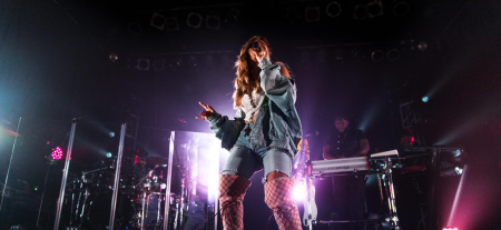 Woman singing on a stage.
