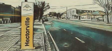 A sign by the side of the road that says 'Hectorville'.