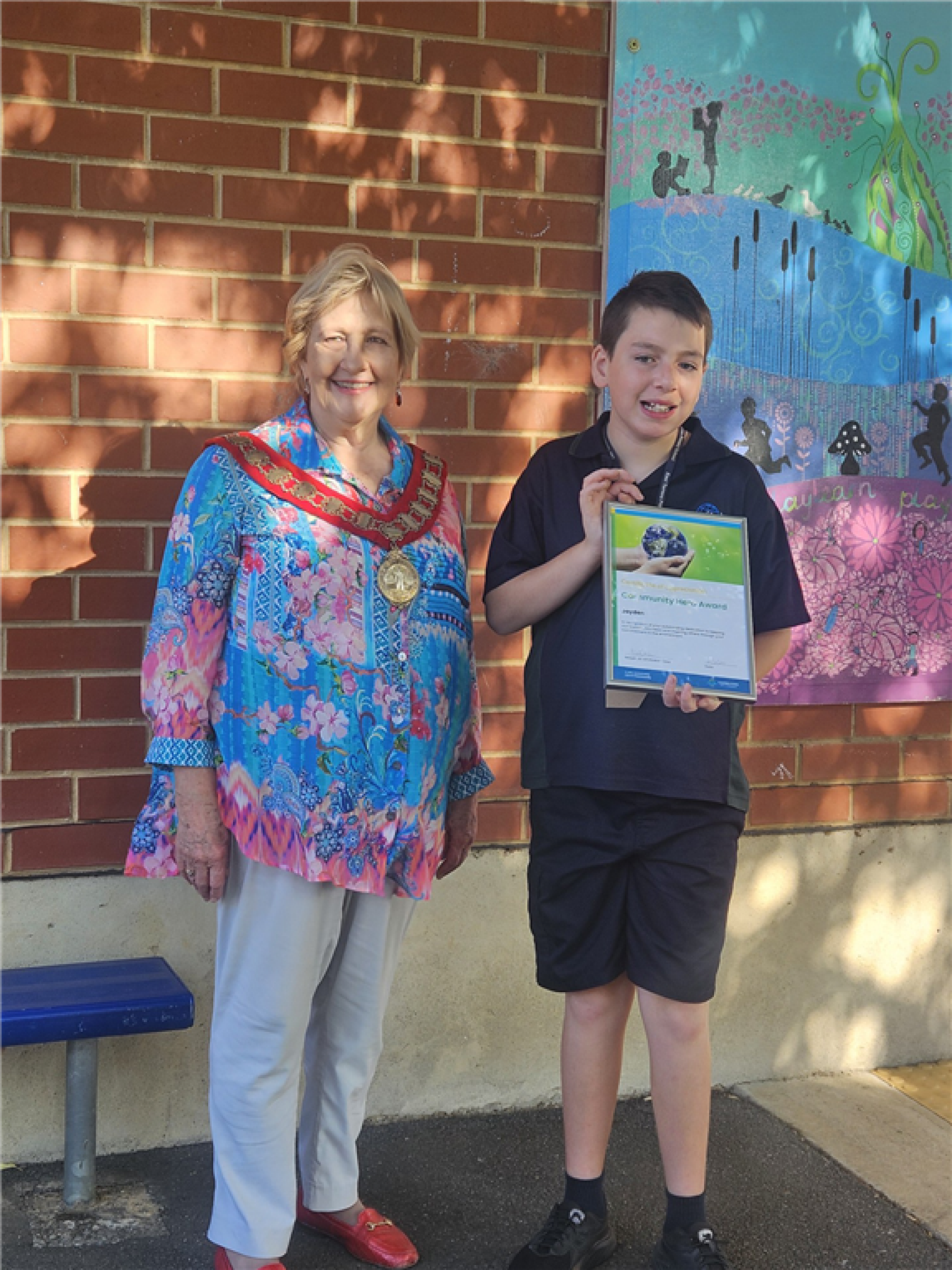 Jayden with Mayor Jill Whittaker OAM and his 'Community Hero Award'.