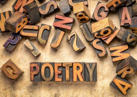 Letter stamps spelling out the word 'poetry'.