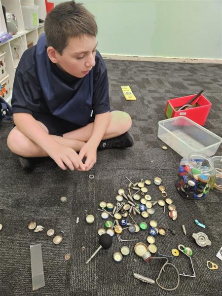 Jayden sorting metal he has collected.