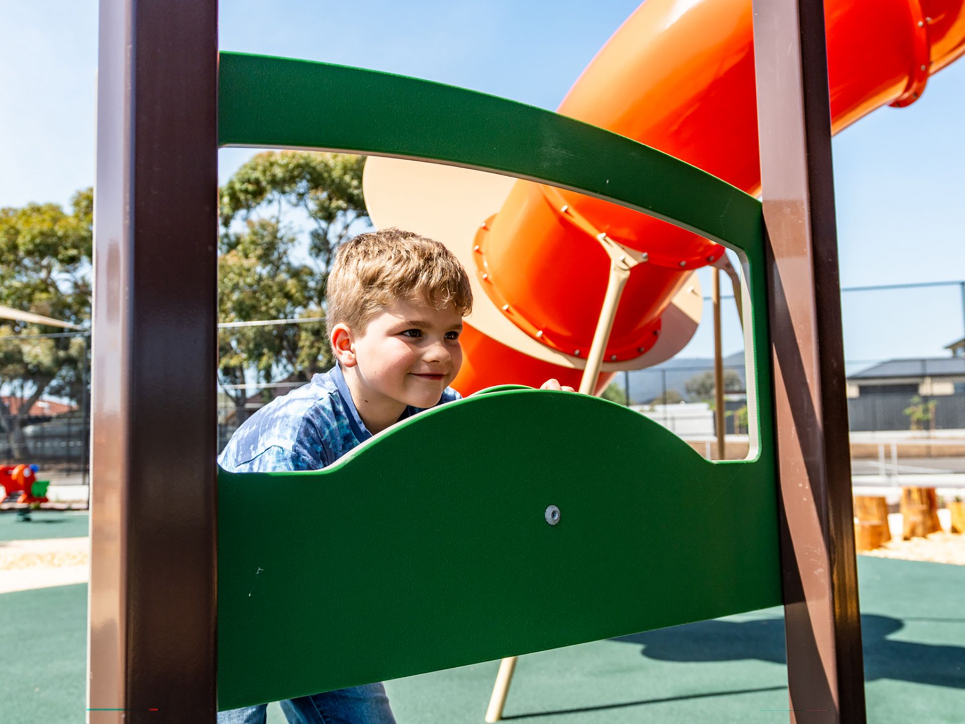A child playing with steering wheel play equipment. at Playford Road Reserve